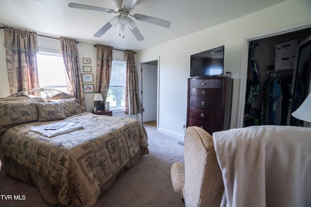 bedroom featuring light carpet, ceiling fan, a closet, and multiple windows