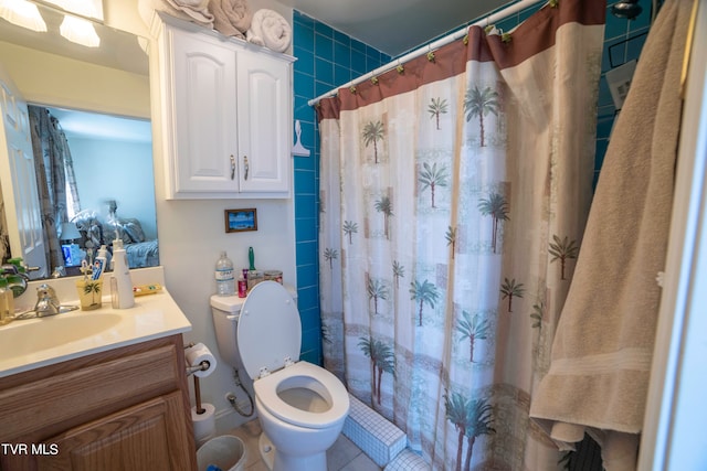 bathroom featuring tile flooring, oversized vanity, and toilet