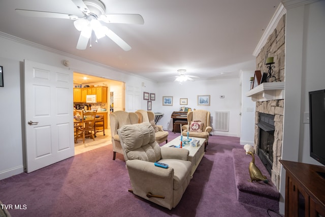 carpeted living room featuring ceiling fan, ornamental molding, and a fireplace