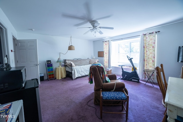 bedroom with ceiling fan and dark colored carpet