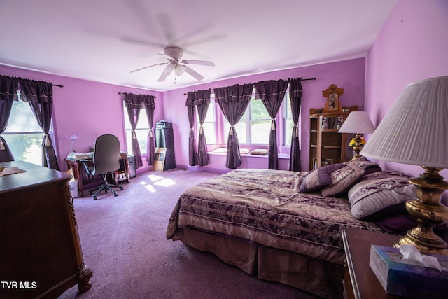 carpeted bedroom with multiple windows and ceiling fan