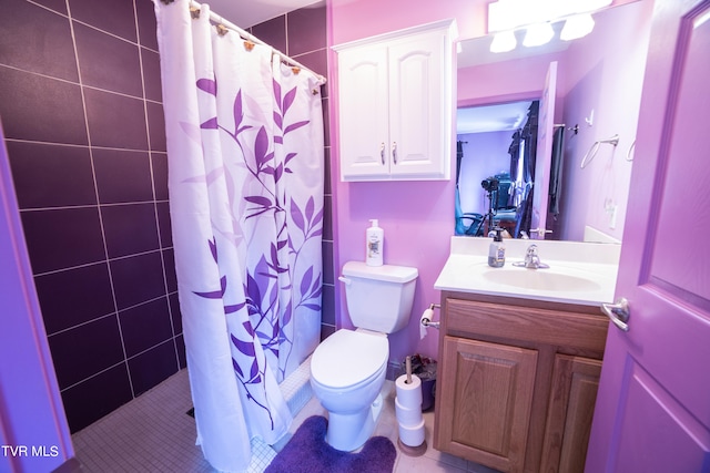 bathroom with tile floors, toilet, and vanity