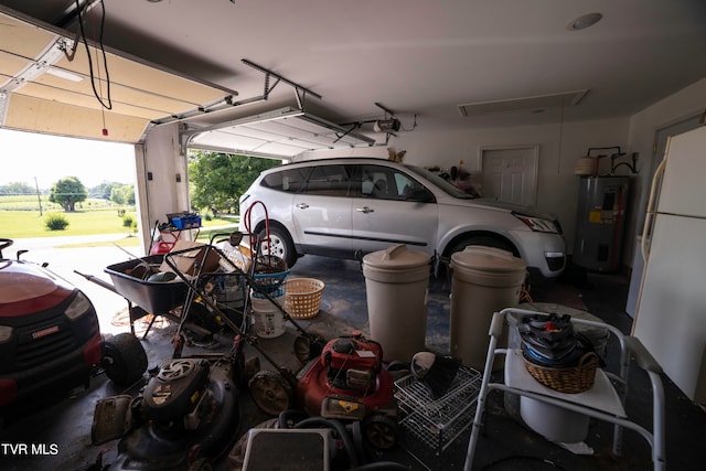 garage with a garage door opener, white fridge, and water heater