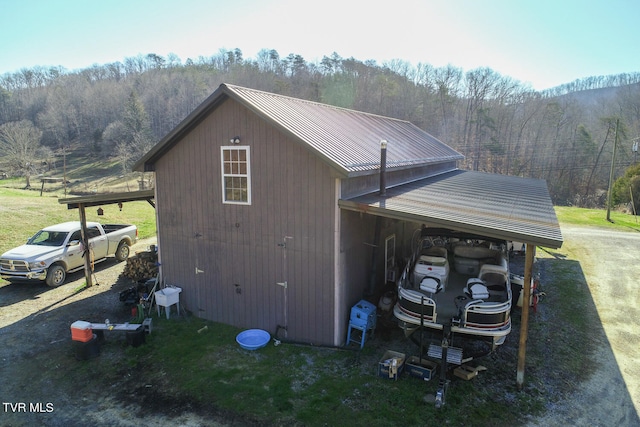 exterior space with a carport and an outdoor structure