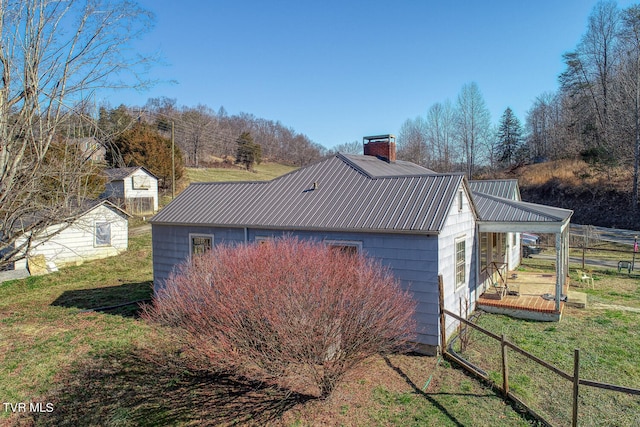 view of side of property with a storage unit