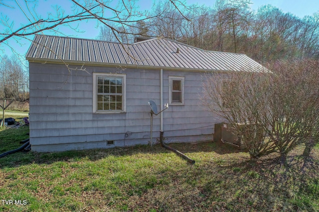 view of side of home featuring a lawn