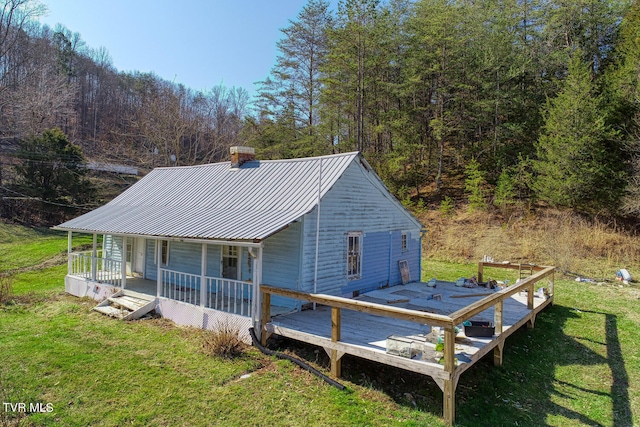 view of front of house with a front yard and a porch