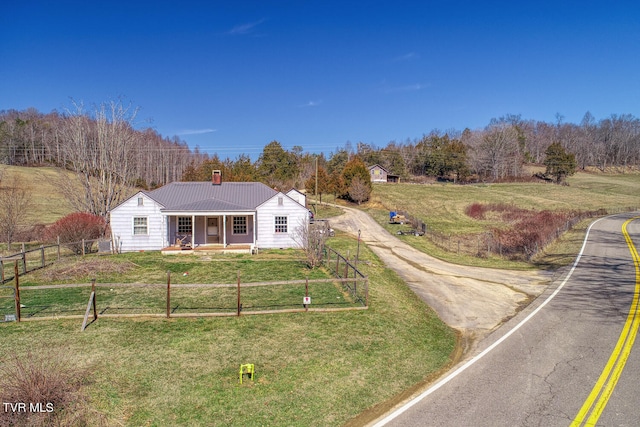 view of front of home featuring a rural view and a front lawn