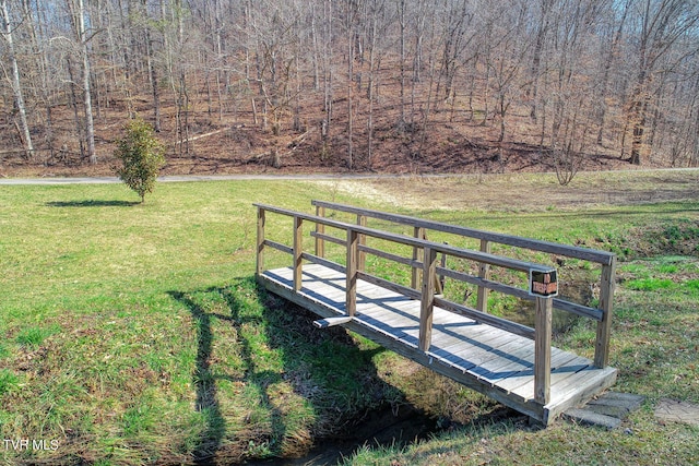 view of property's community with a wooden deck and a lawn