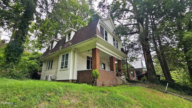 view of side of property featuring a porch