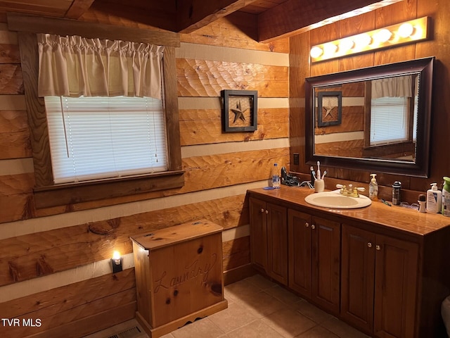 bathroom featuring vanity, tile patterned floors, and wood walls