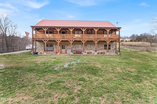 rear view of house featuring a lawn