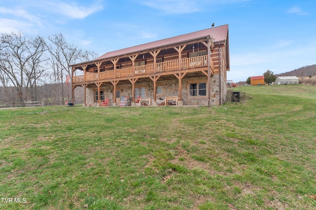 rear view of property featuring a lawn and central air condition unit