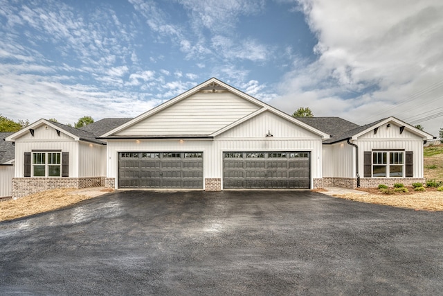 modern farmhouse style home featuring a garage