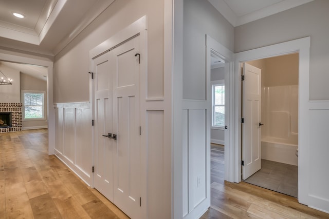 hallway featuring a chandelier and light tile flooring