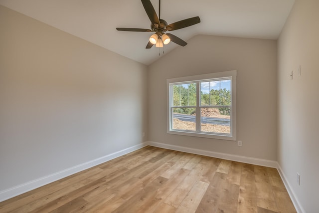 empty room with lofted ceiling, light hardwood / wood-style floors, and ceiling fan