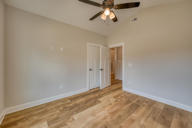 empty room with light hardwood / wood-style flooring, ceiling fan, and high vaulted ceiling