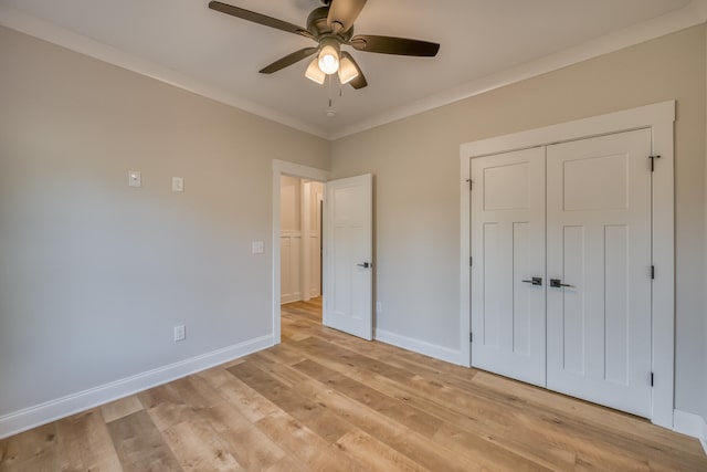 unfurnished bedroom featuring ornamental molding, a closet, ceiling fan, and light hardwood / wood-style flooring