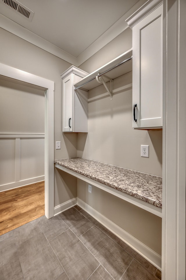 interior space with built in desk and wood-type flooring