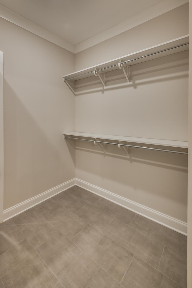 spacious closet featuring light tile floors