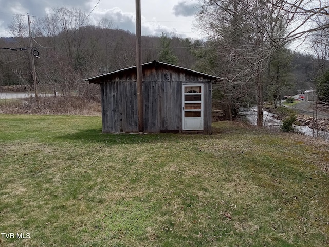 view of outdoor structure with a lawn