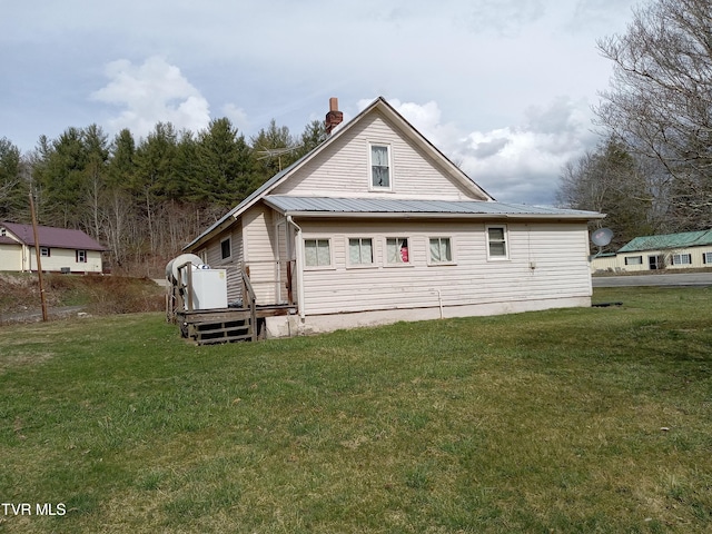 back of property with a lawn