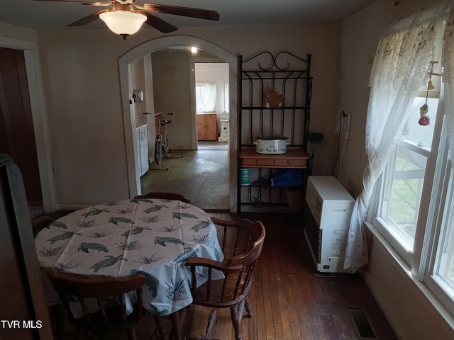 dining area featuring ceiling fan and dark wood-type flooring