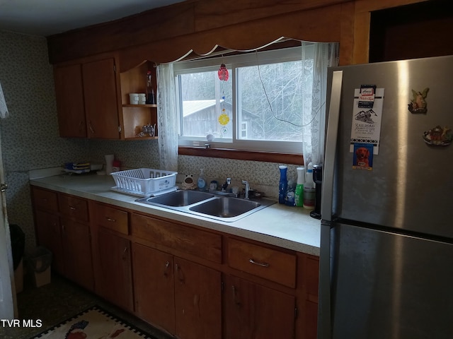 kitchen featuring stainless steel fridge and sink