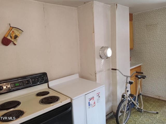 kitchen featuring tile floors, range, and fridge