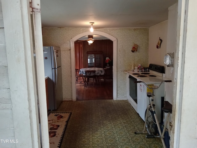 hall featuring dark tile floors