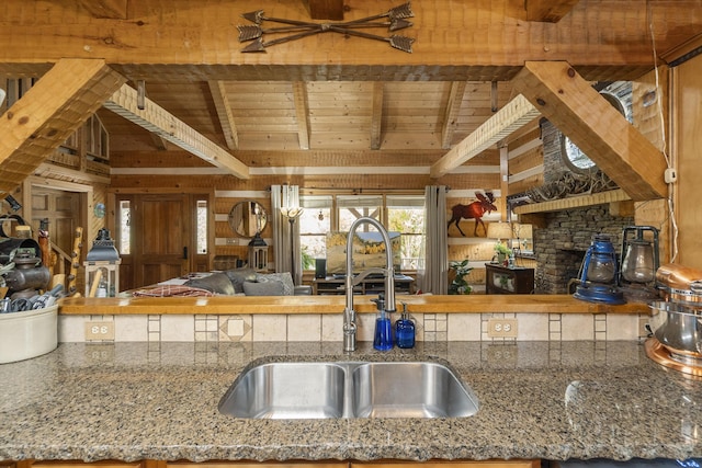 570 Stephen Brooks Rd, Greeneville, TN 37743 - kitchen featuring a sink, wood ceiling with exposed beams, open floor plan, stone counters, and wooden walls