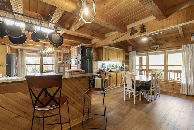 570 Stephen Brooks Rd, Greeneville, TN 37743 - kitchen with stainless steel fridge, wooden ceiling with exposed beams, a chandelier, hardwood / wood-style flooring, and a kitchen breakfast bar