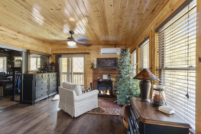 570 Stephen Brooks Rd, Greeneville, TN 37743 - living area featuring a wall unit AC, a glass covered fireplace, wood finished floors, wood walls, and ceiling fan