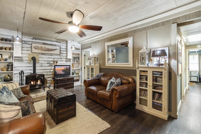 570 Stephen Brooks Rd, Greeneville, TN 37743 - living room featuring a wood stove, wood finished floors, ceiling fan, wood walls, and wood ceiling