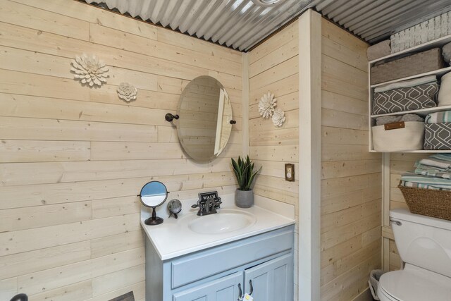 570 Stephen Brooks Rd, Greeneville, TN 37743 - half bath featuring wood walls, vanity, and toilet