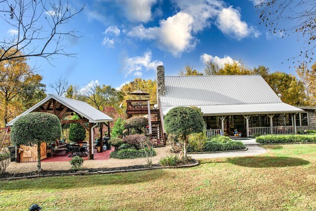 570 Stephen Brooks Rd, Greeneville, TN 37743 - back of property featuring a gazebo, a lawn, a chimney, stairway, and metal roof