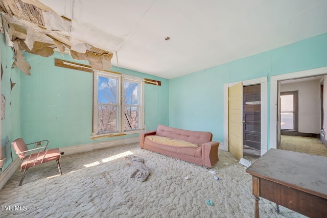 living room with plenty of natural light and carpet flooring