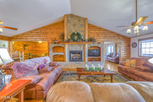 living room featuring a fireplace, ceiling fan, rustic walls, hardwood / wood-style floors, and lofted ceiling