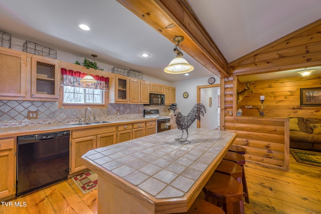 kitchen with sink, light hardwood / wood-style flooring, black appliances, and tile countertops