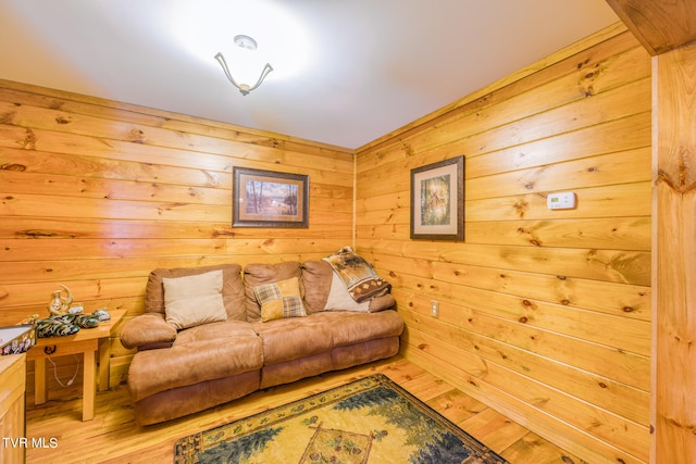 living room featuring light hardwood / wood-style floors and wooden walls