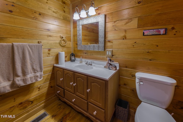 bathroom featuring wood walls and toilet