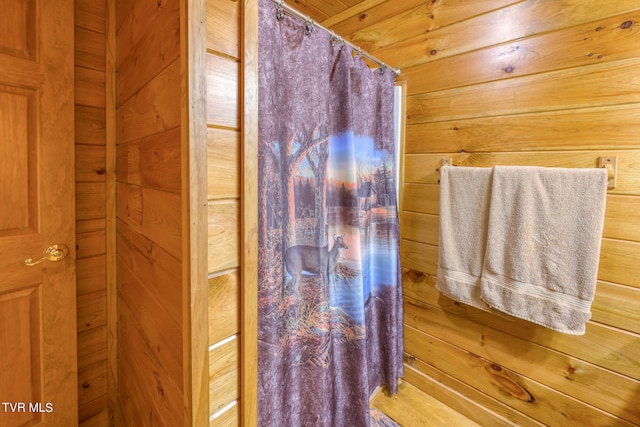 bathroom with wood walls