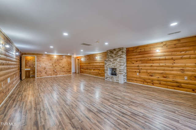 basement with light hardwood / wood-style flooring and a fireplace