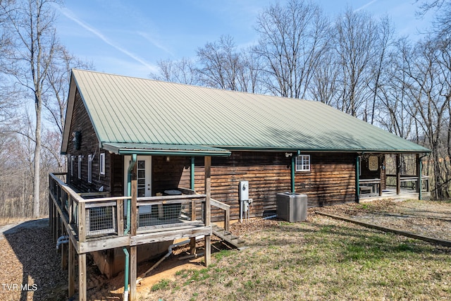 exterior space featuring central AC unit and a deck