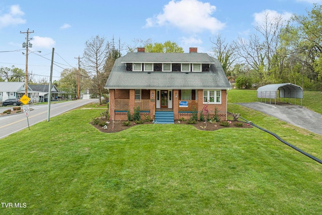 view of front of home featuring covered porch, a front yard, and a carport