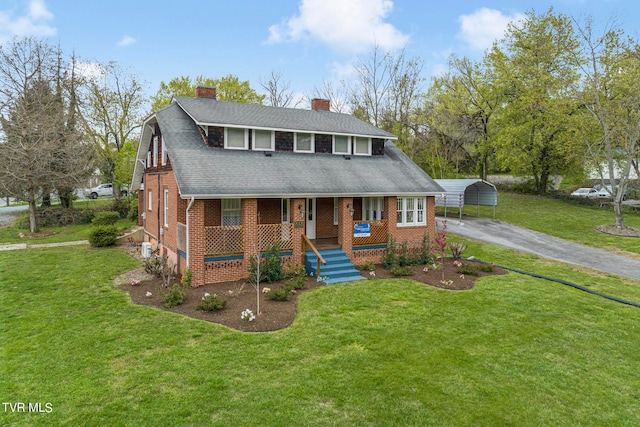 view of front of house featuring a front yard, covered porch, and a carport