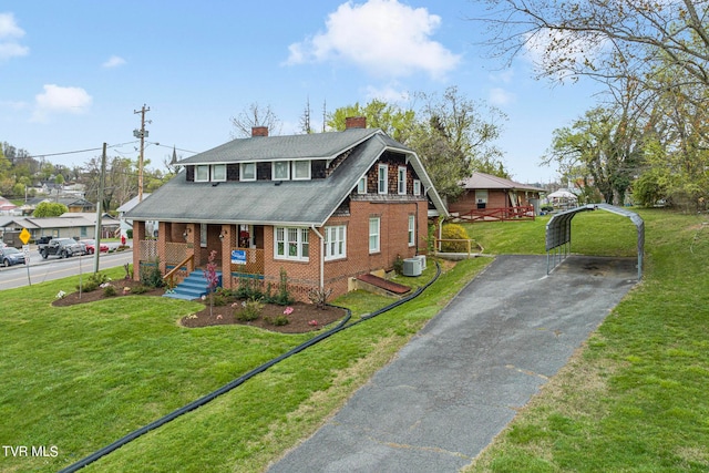 view of front facade with central AC and a front yard