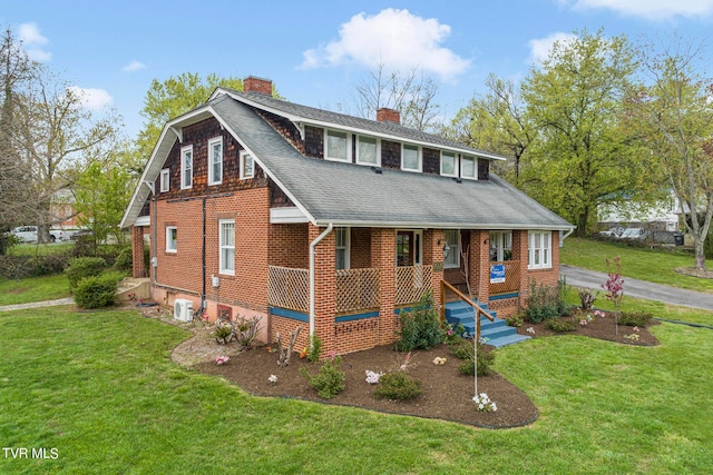 view of front of home with a front yard and covered porch