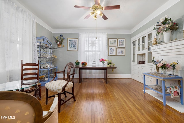 living area featuring ceiling fan and light hardwood / wood-style flooring