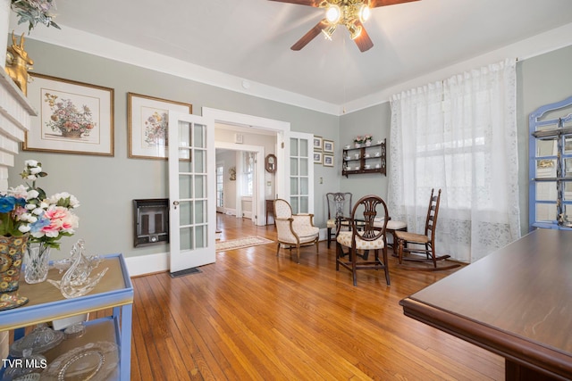 dining area with french doors, ornamental molding, ceiling fan, and light hardwood / wood-style flooring